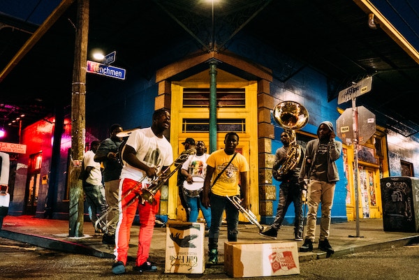 A jazz band play in the street in New Orleans, which is one of the best destinations to visit if you're going through a breakup.